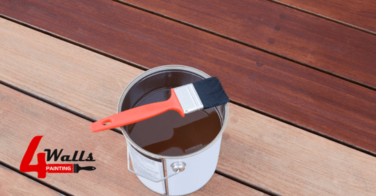 A bucket of deck stain on a deck